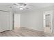 Bedroom with wood-look floors, a ceiling fan, and access to a closet and en-suite bathroom at 8701 Ballantrae Way, Tampa, FL 33647
