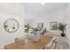 Open-concept dining room showcasing a rustic wooden table with seating for six and elegant decor at 8701 Ballantrae Way, Tampa, FL 33647