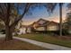 Beautiful two-story home with a manicured lawn and mature trees at 8701 Ballantrae Way, Tampa, FL 33647