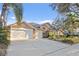 Charming single-story home boasts a well-manicured lawn, three-car garage, and inviting curb appeal at 8701 Ballantrae Way, Tampa, FL 33647