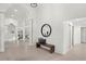 Spacious foyer with tile flooring, arched doorways, and a wooden bench with decorative pillows at 8701 Ballantrae Way, Tampa, FL 33647