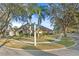 Beautifully landscaped home on a corner lot with mature trees and well-maintained lawn at 8701 Ballantrae Way, Tampa, FL 33647