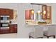 Charming kitchen with built-in oven, counter seating, and modern lighting fixtures at 8701 Ballantrae Way, Tampa, FL 33647