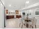 Eat-in kitchen area features high ceilings, a dining table, pendant lighting, and modern decor at 8701 Ballantrae Way, Tampa, FL 33647