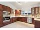 Well-lit kitchen with dark cabinetry, stainless steel appliances, and tile flooring at 8701 Ballantrae Way, Tampa, FL 33647