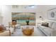 Sunlit living room offering a view of screened-in pool and patio at 8701 Ballantrae Way, Tampa, FL 33647