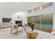 Bright living room boasts fireplace and clear view of screened pool area at 8701 Ballantrae Way, Tampa, FL 33647