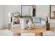 Cozy living room with a neutral sofa, stylish vases on the coffee table and modern decor at 8701 Ballantrae Way, Tampa, FL 33647