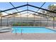 Screened-in pool and spa with brick paving and view of the backyard at 8701 Ballantrae Way, Tampa, FL 33647