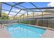 Screened-in pool and spa with backyard view and lush landscaping at 8701 Ballantrae Way, Tampa, FL 33647