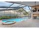 Screened-in pool and spa with brick paving at 8701 Ballantrae Way, Tampa, FL 33647
