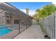 View of the pool with attached jacuzzi and brick-paved patio, along with an outdoor kitchen and grill area under screened enclosure at 8701 Ballantrae Way, Tampa, FL 33647