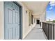 Building hallway with blue door and balcony access at 9825 Harrell Ave # 202, Treasure Island, FL 33706