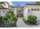 Landscaped front yard with a walkway leading to the home's entrance at 10169 Lenox Blvd, Weeki Wachee, FL 34613