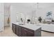 Modern kitchen island with marble countertop and a double sink at 10169 Lenox Blvd, Weeki Wachee, FL 34613