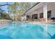 Refreshing pool with a spa and screened enclosure at 10169 Lenox Blvd, Weeki Wachee, FL 34613