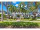 Two-story home with gray siding, lush landscaping, and palm trees at 135 6Th Ne Ave, St Petersburg, FL 33701