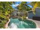 Inviting kidney-shaped pool surrounded by lush landscaping at 135 6Th Ne Ave, St Petersburg, FL 33701