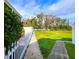 Landscaped backyard with a grassy area and walkway at 13763 Juniper Blossom Dr # 101, Tampa, FL 33618