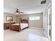 Main bedroom with a king-size bed and ceiling fan at 13956 75Th Ave, Seminole, FL 33776