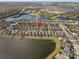 Aerial view of house and neighborhood near lake at 15521 Long Cypress Dr, Ruskin, FL 33573