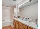 Bathroom with double vanity and shower at 15521 Long Cypress Dr, Ruskin, FL 33573