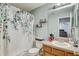 Clean bathroom with tub shower combo and wood vanity at 15521 Long Cypress Dr, Ruskin, FL 33573