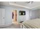 Main bedroom with ensuite bathroom and TV at 15521 Long Cypress Dr, Ruskin, FL 33573