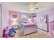 Bright bedroom with purple walls and a full bed at 15521 Long Cypress Dr, Ruskin, FL 33573
