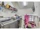 Laundry room with washer, dryer, and shelving at 15521 Long Cypress Dr, Ruskin, FL 33573