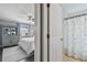 Bedroom with white bedding, built-in shelving and adjacent bathroom at 19201 Vista Ln # C8, Indian Shores, FL 33785
