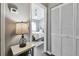Guest bedroom with white louvered doors and access to bathroom at 19201 Vista Ln # C8, Indian Shores, FL 33785