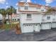 Front view of white two-story condo with attached garage at 19201 Vista Ln # C8, Indian Shores, FL 33785