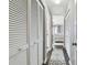 Hallway with two white louvered doors and dark hardwood floors at 19201 Vista Ln # C8, Indian Shores, FL 33785