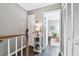 Bright hallway with white louvered doors and a small table at 19201 Vista Ln # C8, Indian Shores, FL 33785