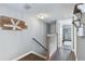 Upper level hallway with hardwood floors and access to bedrooms at 19201 Vista Ln # C8, Indian Shores, FL 33785