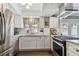 Modern kitchen with stainless steel appliances and white cabinets at 19201 Vista Ln # C8, Indian Shores, FL 33785