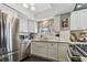 Updated kitchen featuring stainless steel appliances and white cabinetry at 19201 Vista Ln # C8, Indian Shores, FL 33785