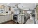 Modern kitchen with white cabinets, stainless steel appliances, and hardwood floors at 19201 Vista Ln # C8, Indian Shores, FL 33785