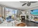 Cozy living room featuring a fireplace and access to a deck at 19201 Vista Ln # C8, Indian Shores, FL 33785