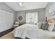Main bedroom with hardwood floors, and white bedding at 19201 Vista Ln # C8, Indian Shores, FL 33785