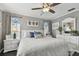 Main bedroom with king bed, white dresser and large windows at 19201 Vista Ln # C8, Indian Shores, FL 33785