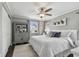 Spacious main bedroom with a king-size bed, ceiling fan, and gray walls at 19201 Vista Ln # C8, Indian Shores, FL 33785