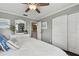 Main bedroom with king bed, white dresser and access to the hallway at 19201 Vista Ln # C8, Indian Shores, FL 33785