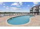 Community pool with lounge chairs and waterfront views at 19201 Vista Ln # C8, Indian Shores, FL 33785