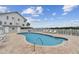 Community pool with lounge chairs at 19201 Vista Ln # C8, Indian Shores, FL 33785
