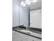 Clean bathroom with single vanity and dark countertop at 20000 Outpost Pt Dr, Tampa, FL 33647