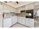 White kitchen with granite countertops and modern appliances at 2311 Brisbane St # 1, Clearwater, FL 33763