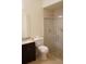 Bathroom with toilet, shower, and granite vanity at 2320 Marksmen Ct # 205, Sun City Center, FL 33573