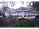 Home exterior showcasing a sunroom addition and landscaping at 2320 Marksmen Ct # 205, Sun City Center, FL 33573